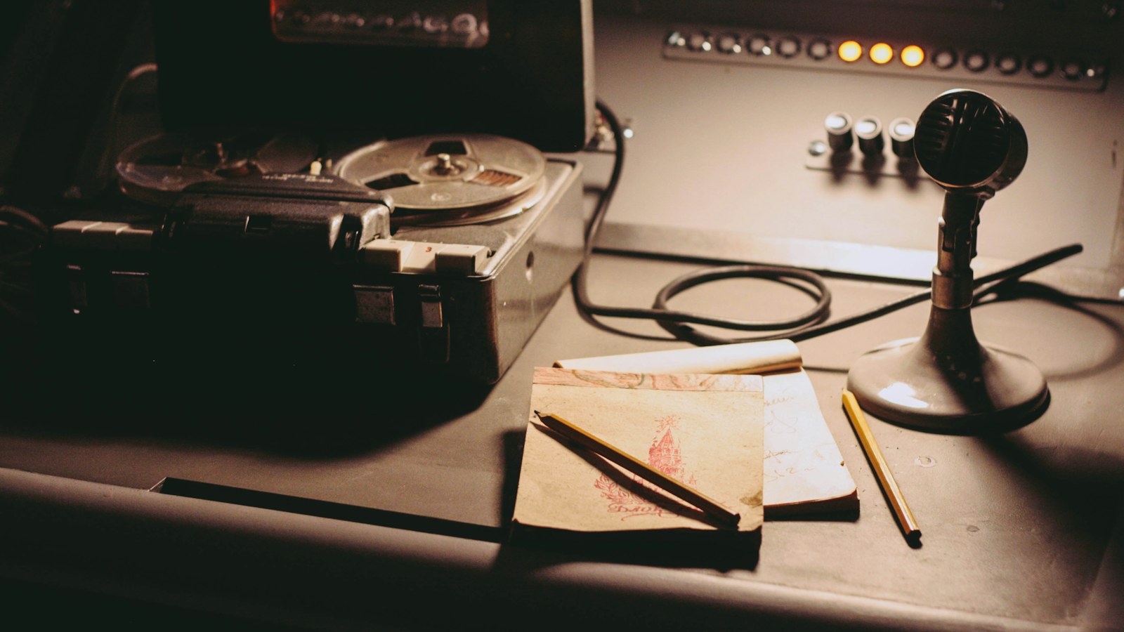 Reel-to-reel tape recorder and handwritten notes on a studio desk