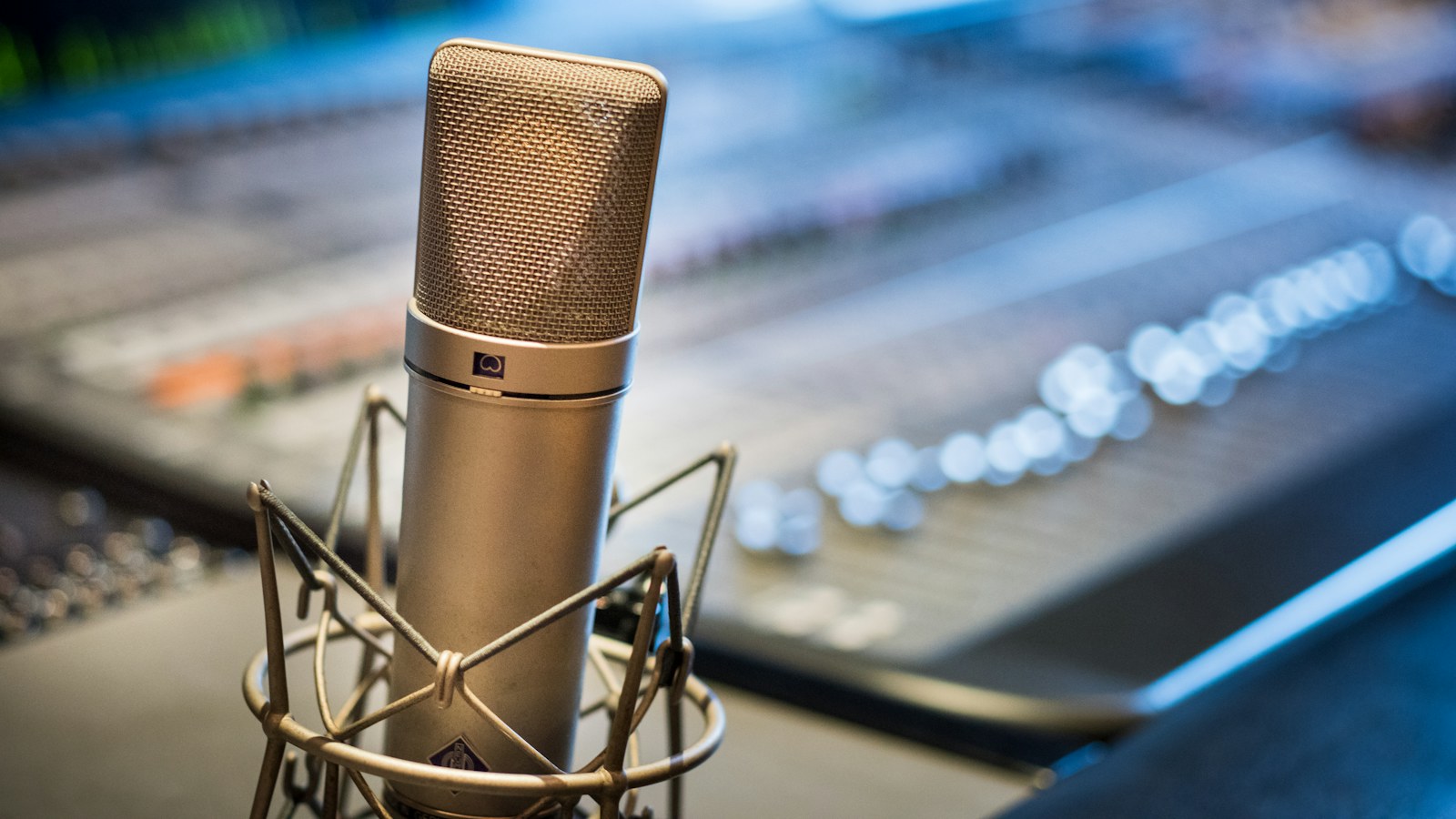 Condenser microphone in front of a recording studio mixing console